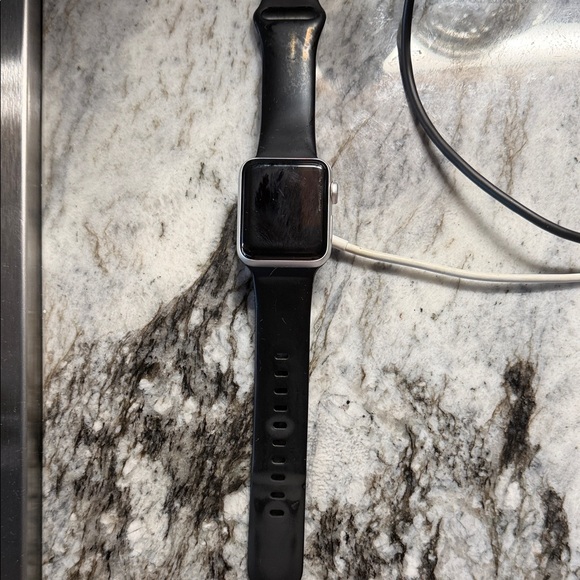 Apple Smartwatch Series 3 38 mm with Black Band Silver Frame and charger.